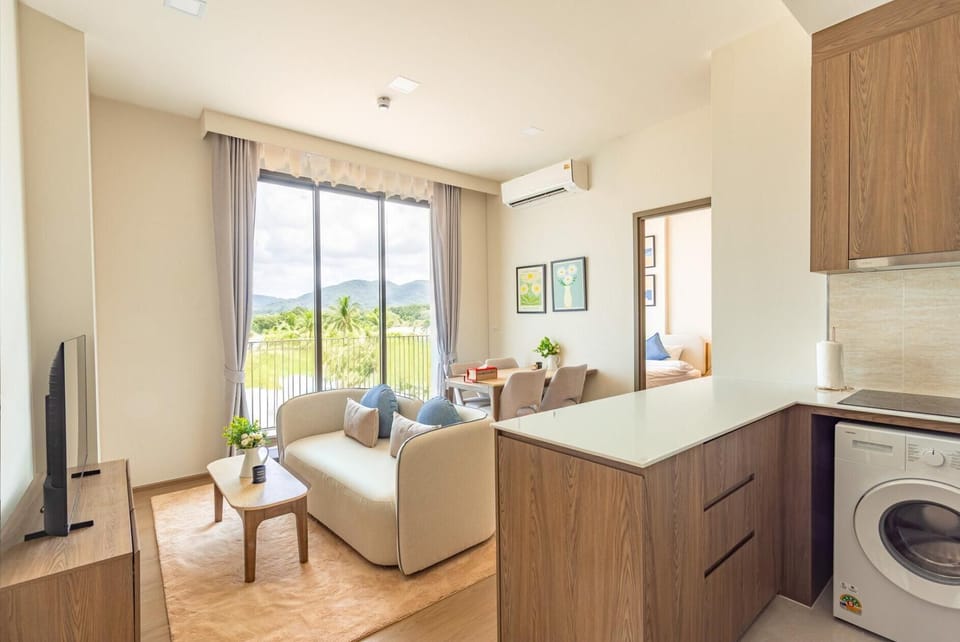 Relaxing living area with soft seating and direct access to the balcony.