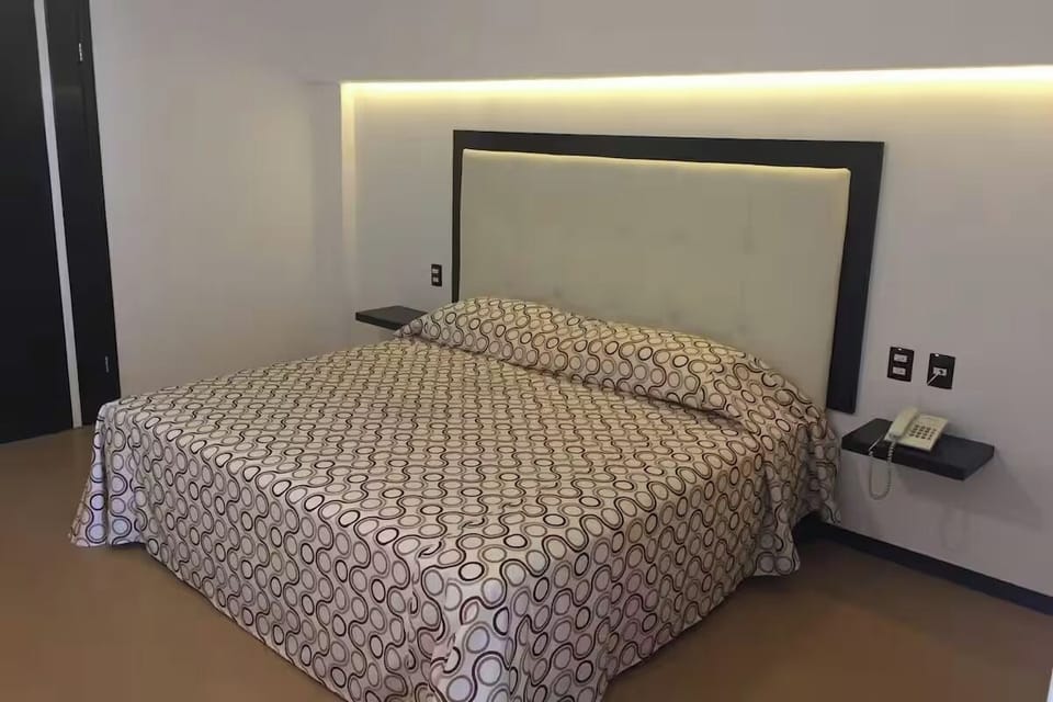 Unwind on a plush king bed under soft lighting.
