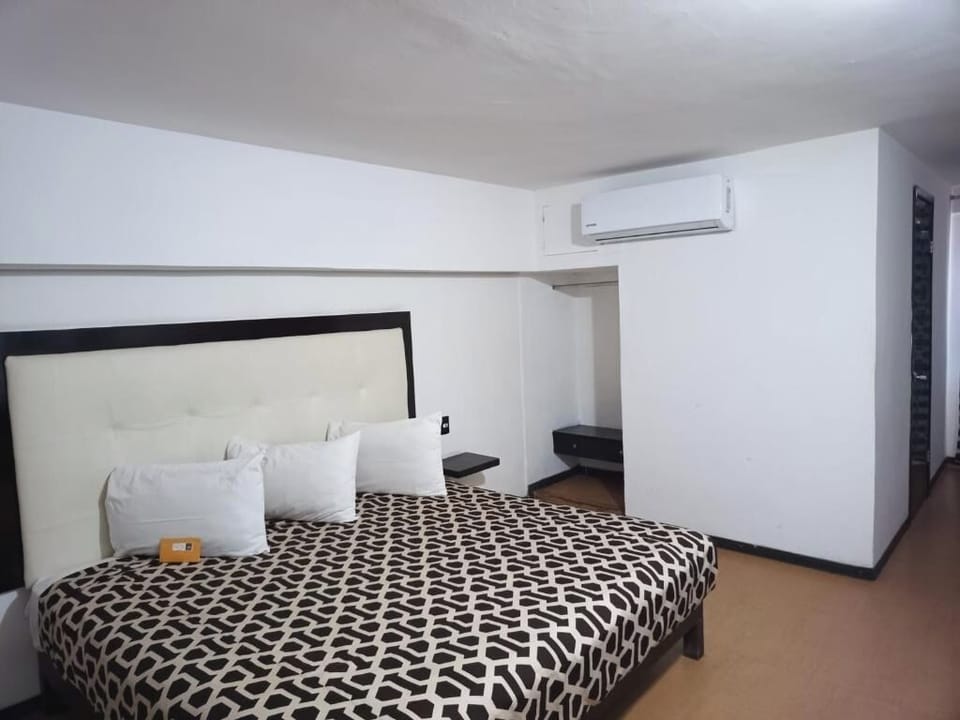 Unwind on a plush king bed beneath cool air-conditioning.