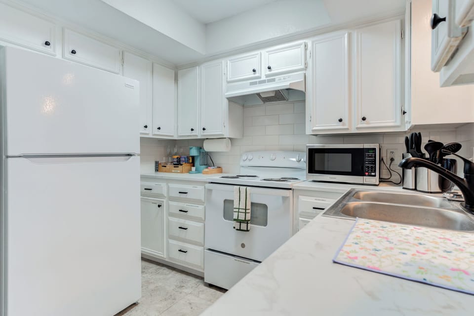 Cook in style with crisp white cabinetry and modern subway tile backsplashes.