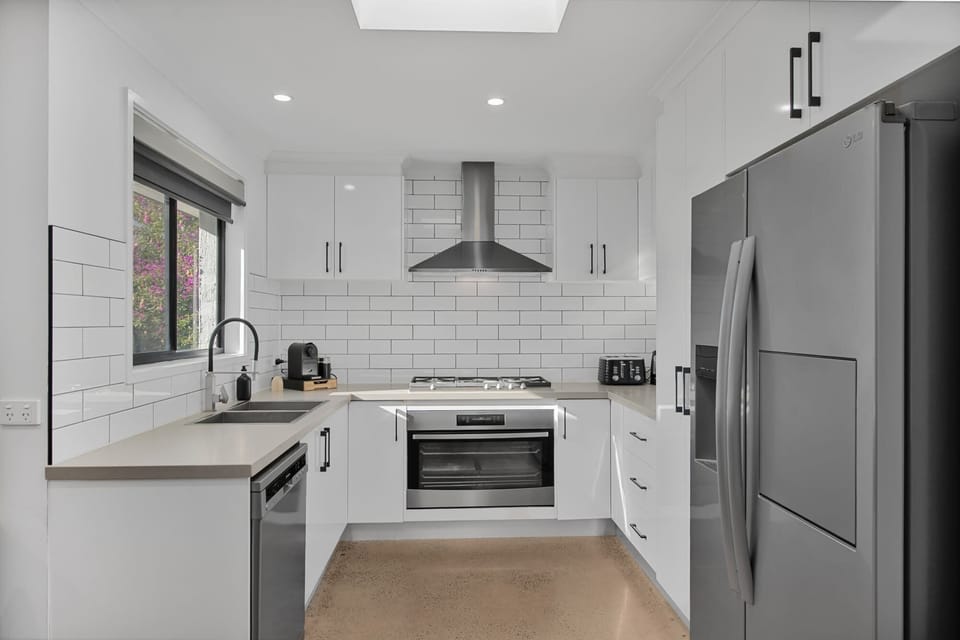 Sleek, modern kitchen with pod coffee machine and quality appliances.