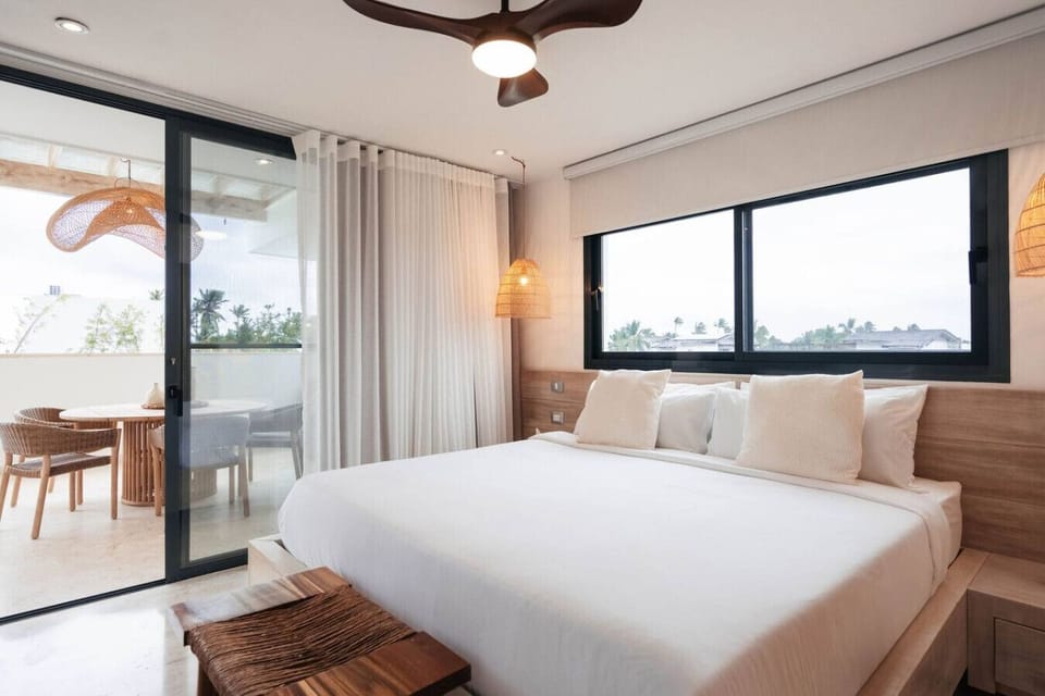 Bedroom 4 features a comfortable king bed and direct access to a private balcony.