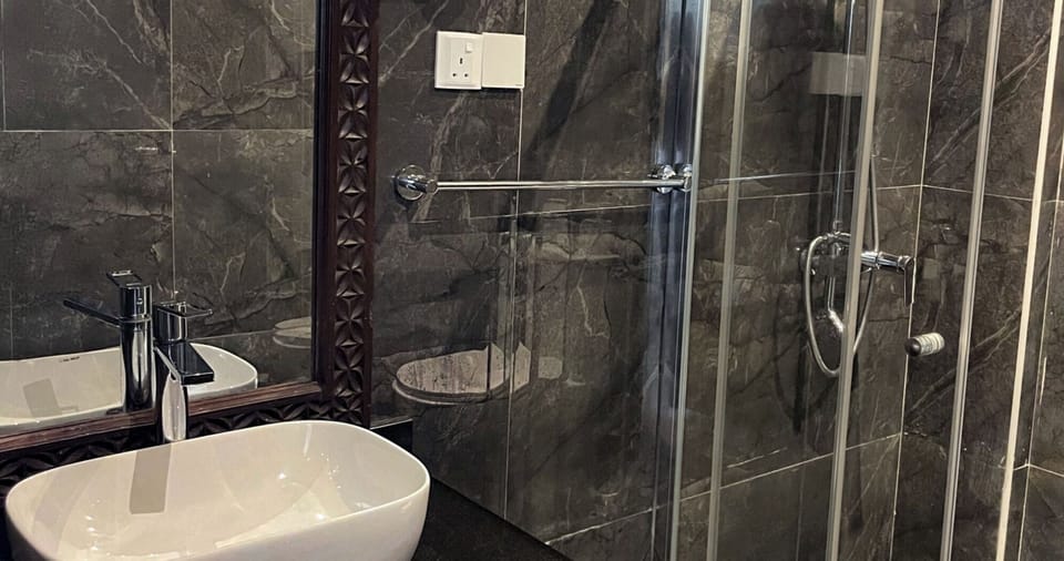 Refresh in a sleek glass shower with modern fixtures.