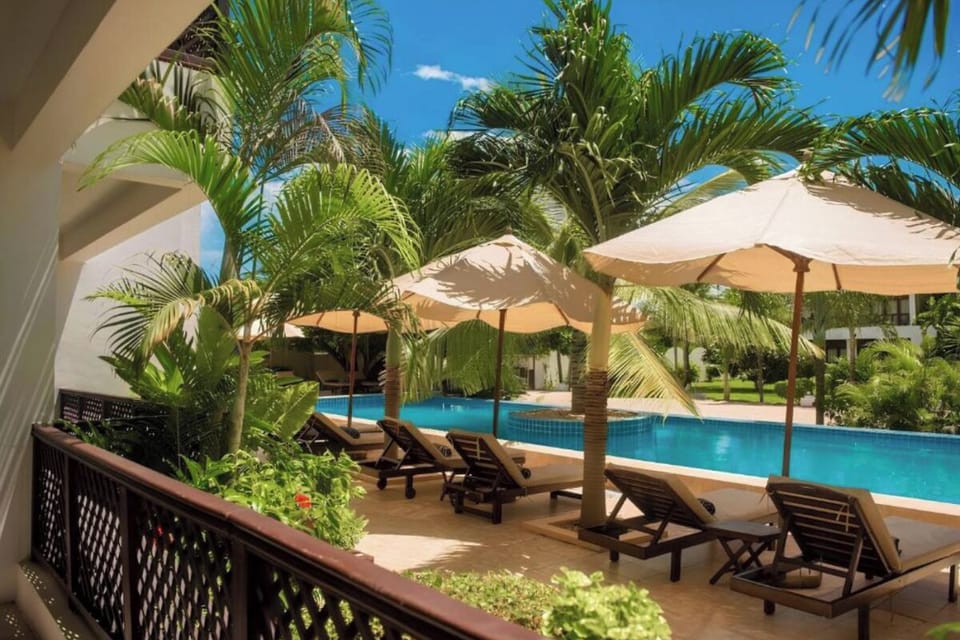 Bask in lush garden shade steps from your lounger.
