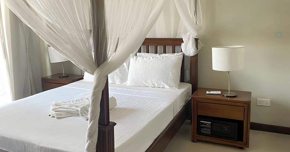 Unwind in crisp linens with bedside lighting and in-room safe.