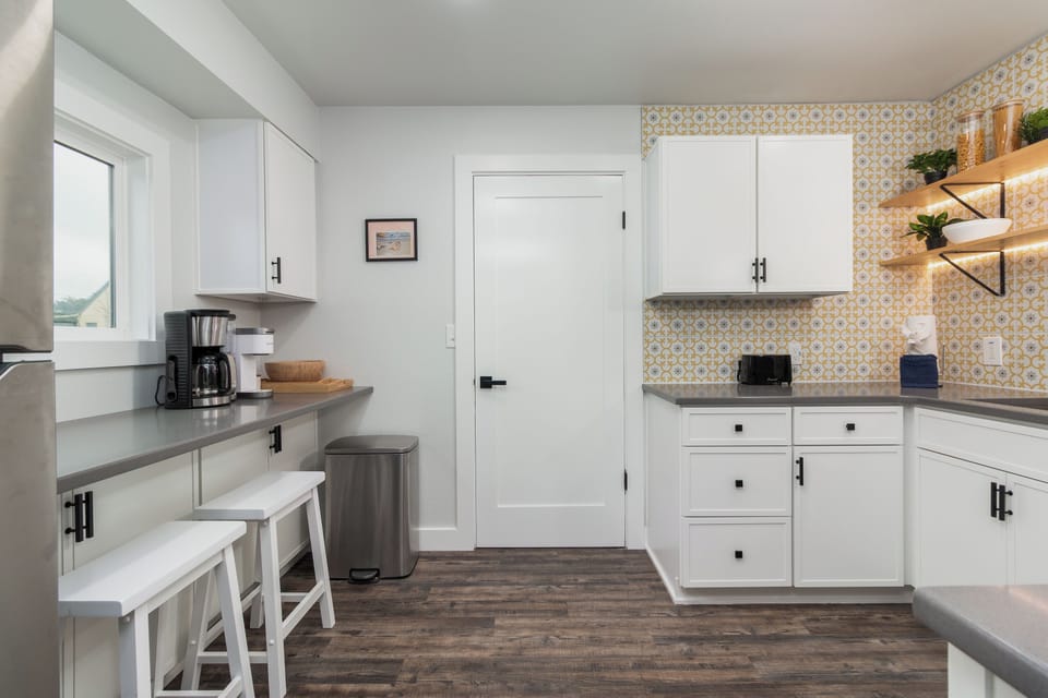 Your modern kitchen features stylish patterned tile backsplash, sleek white cabinets, and everything you need to create memorable meals together.