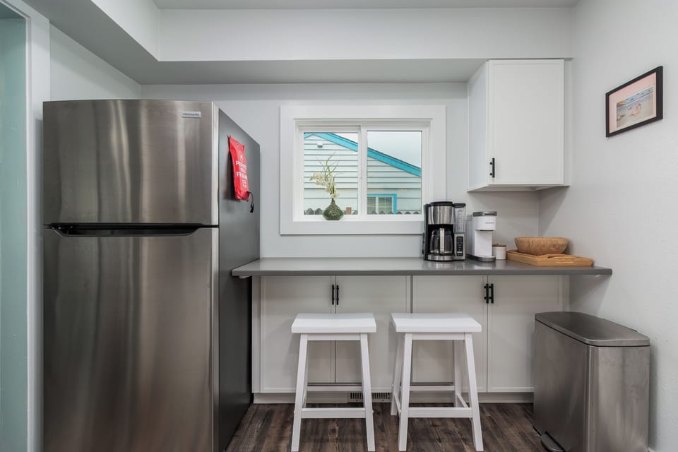 Your modern kitchenette features stainless steel appliances and a breakfast counter where you can enjoy morning coffee.