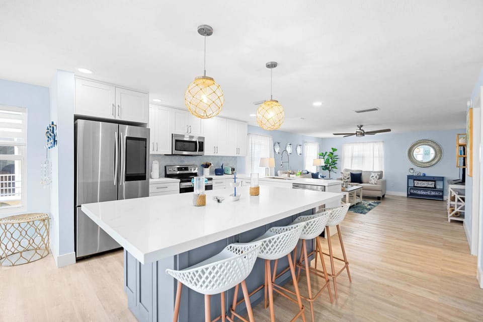 Morning coffee or evening cocktails at the island. Four bar seats, quartz counters, and everything you need to cook in.