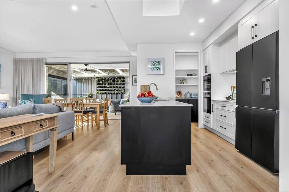 Cook with ease in a fully equipped kitchen, where modern appliances, including a dishwasher, oven, stove, and fridge, support effortless home meals.