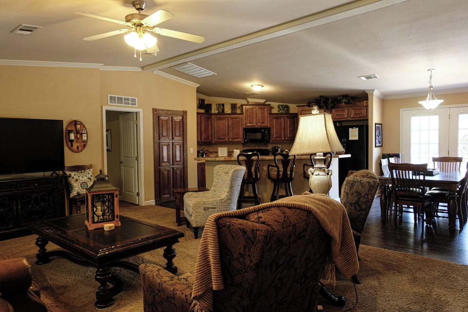 Spacious open living area with full kitchen, bar seating, and dining space