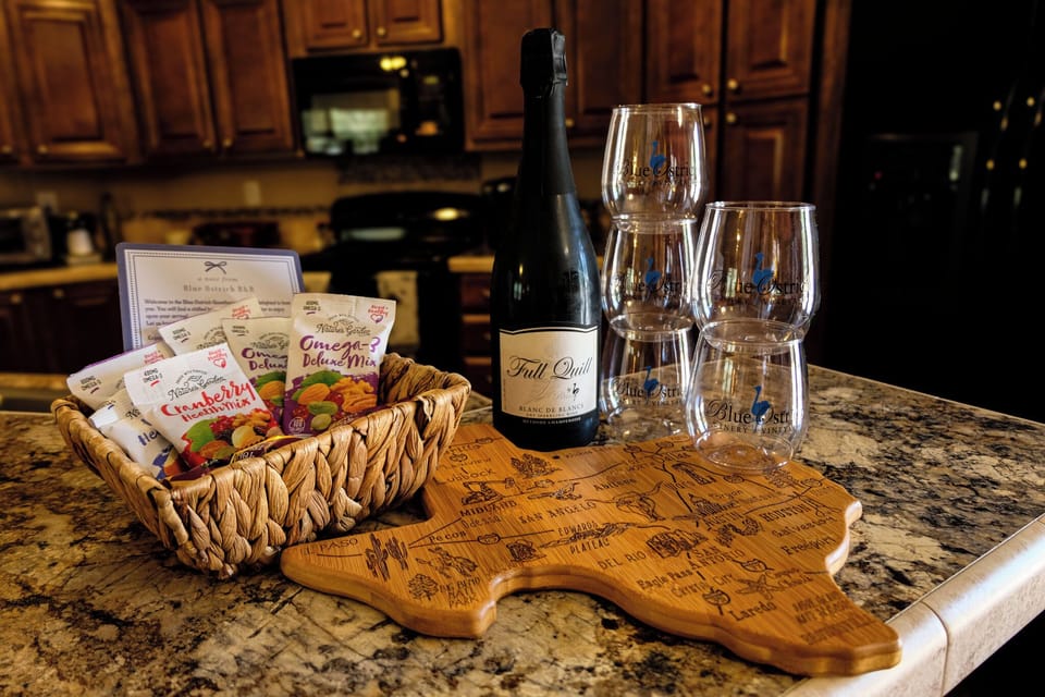 Welcome basket, sparkling wine, and stylish kitchen island setup