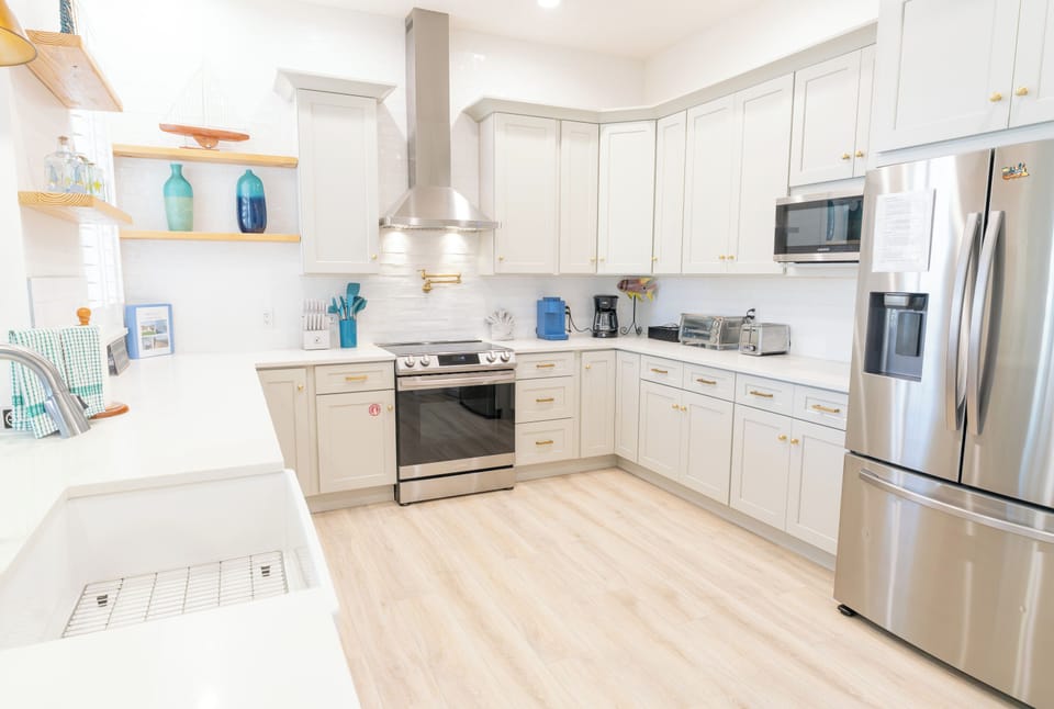 Bright, open, and fully loaded — this kitchen has everything from a French door fridge to a toaster oven, ready for anything from breakfast to a full group dinner.