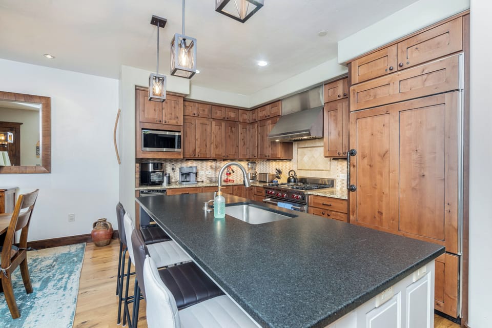 Your gourmet kitchen awaits with rich wood cabinetry, granite countertops, and professional-grade appliances for memorable meal preparation.