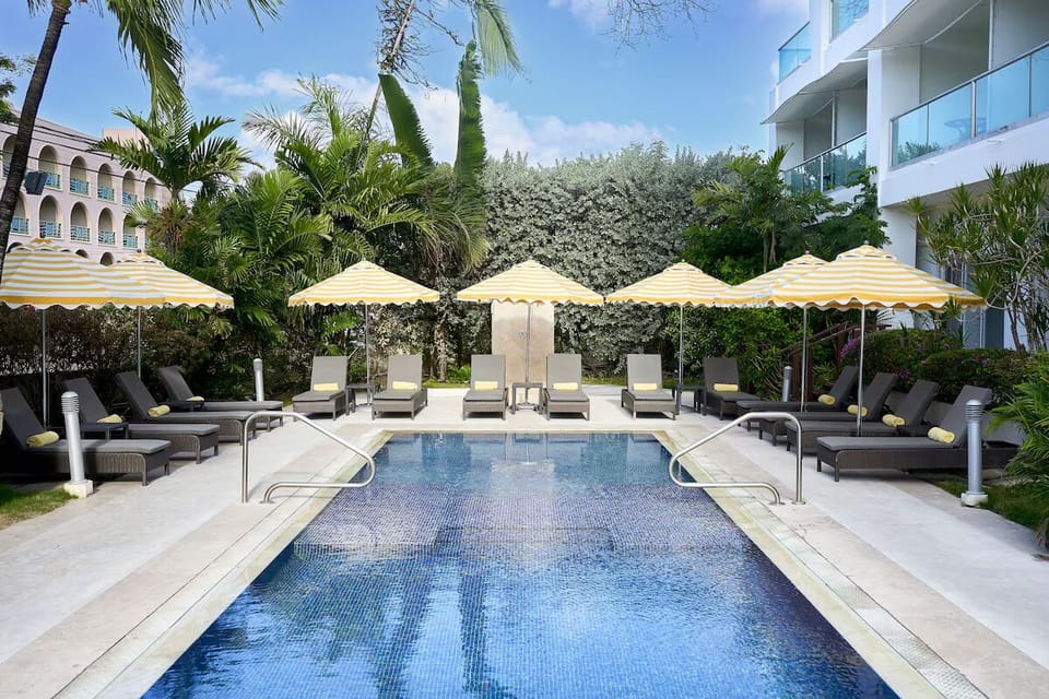 Unwind beside the sparkling pool with shaded loungers.