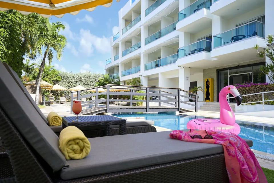 Lounge poolside with chilled drinks and sun-kissed calm.