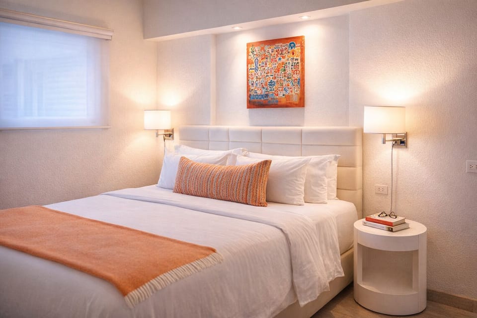 Unwind in crisp linens under warm, calming bedside glow.