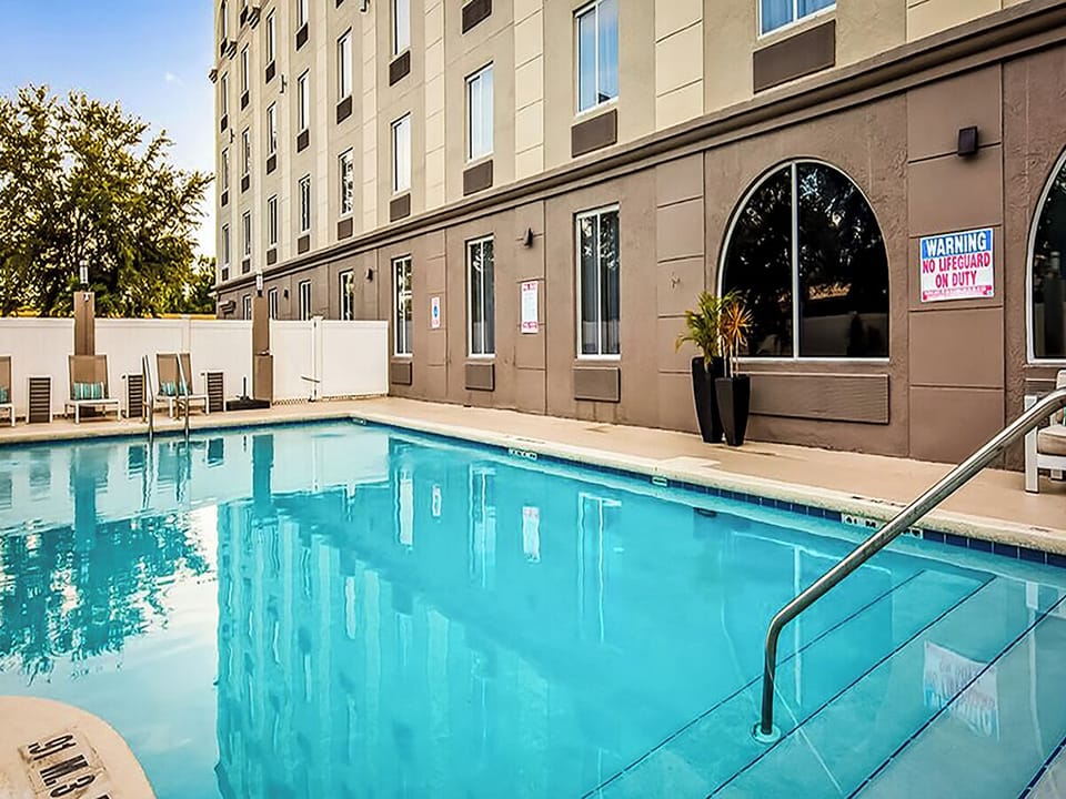 Dive into a refreshing swim in the sunlit outdoor pool.