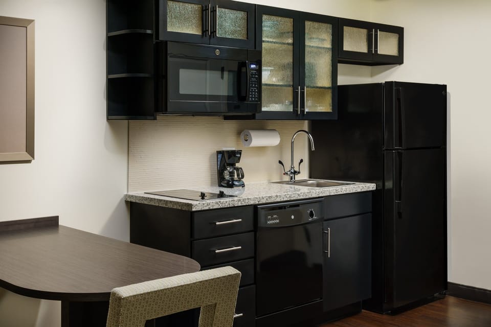 Start mornings with fresh coffee beside the sleek kitchenette.