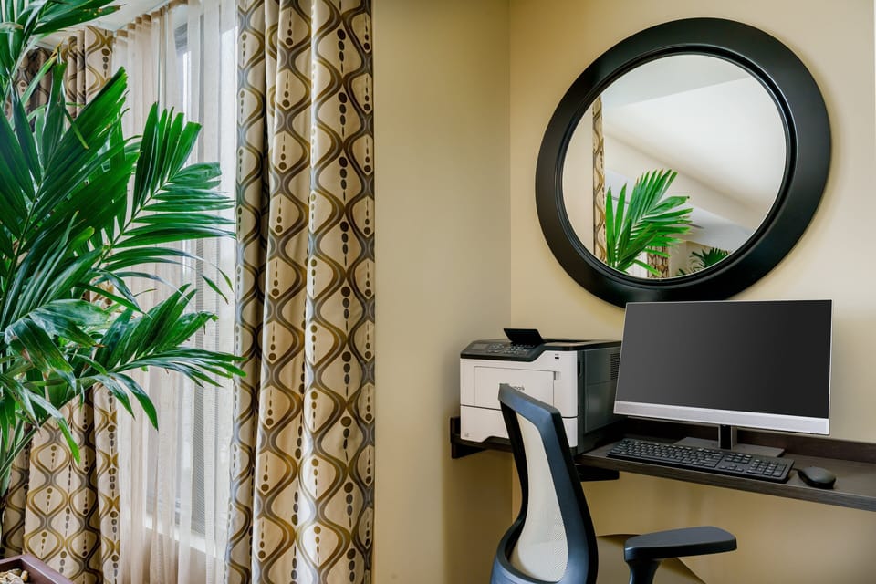 Stay productive with a quiet workstation, monitor, and printing nearby.