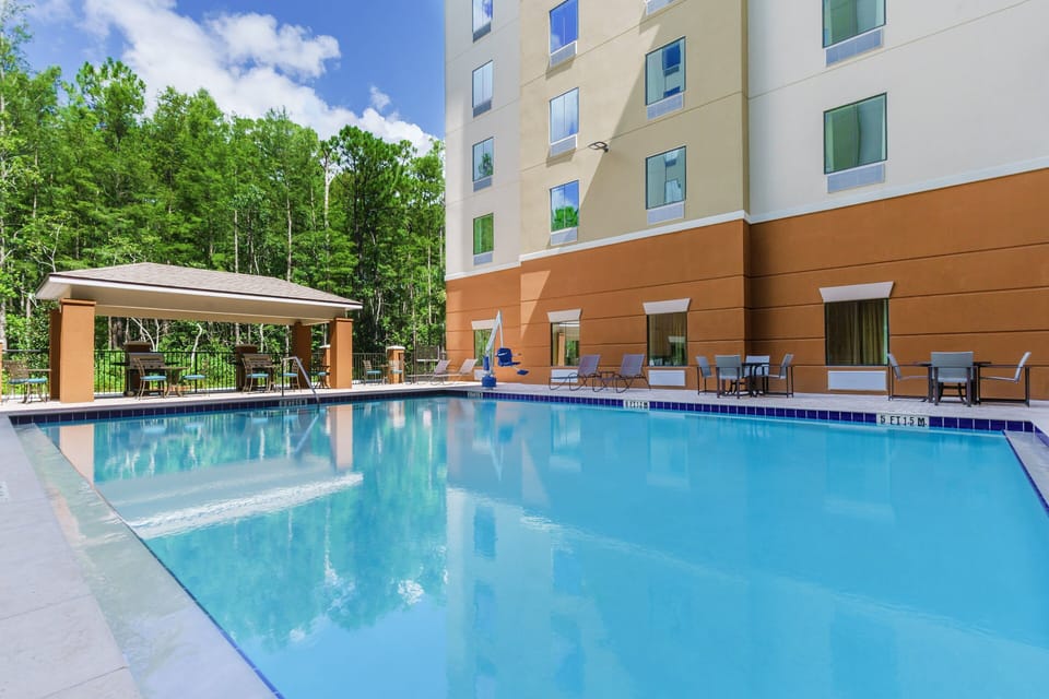 Dive into sunlit relaxation with sparkling poolside loungers and shade.