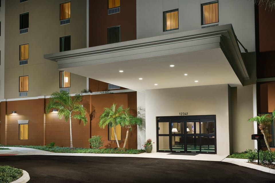 Arrive effortlessly under a bright canopy entrance after travel.