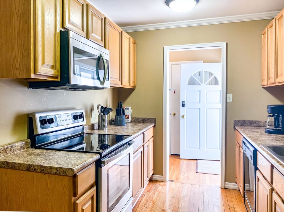 The kitchen offers a comfortable, open space to cook and connect, with enough room for multiple people to move around without feeling crowded. It keeps the rhythm of the home flowing naturally from prep to dining.