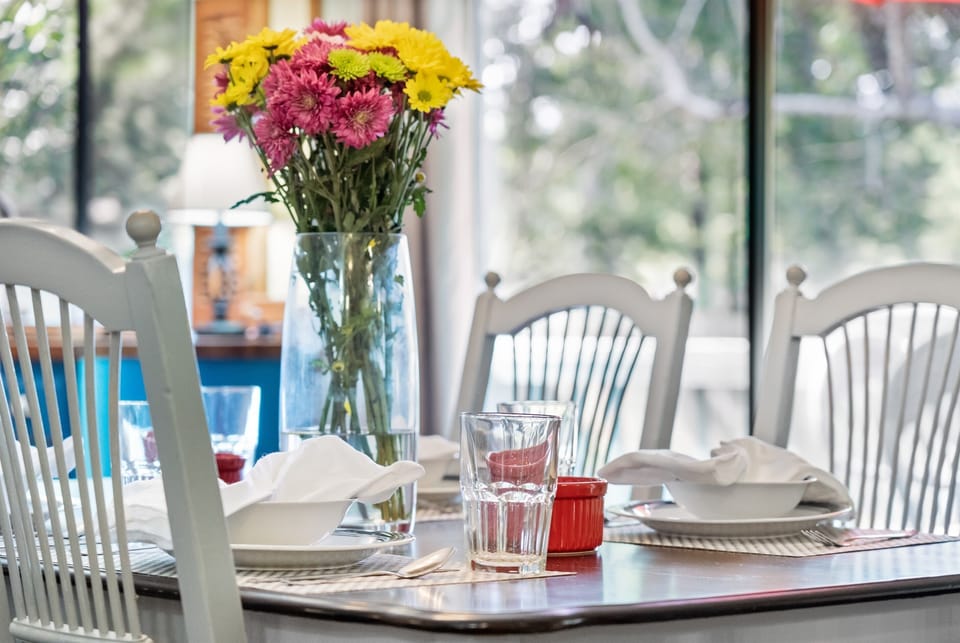 Gather around the dining table, perfect for enjoying meals or spending time together.
