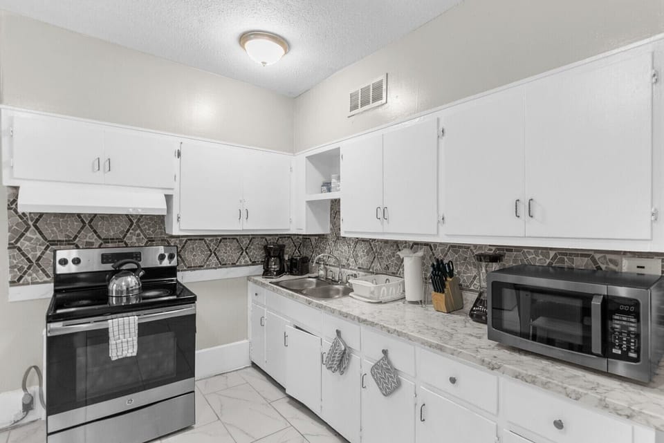 This inviting kitchen offers plenty of space to prepare your favorite dishes, whether you're cooking for the group or just enjoying a quiet morning coffee.