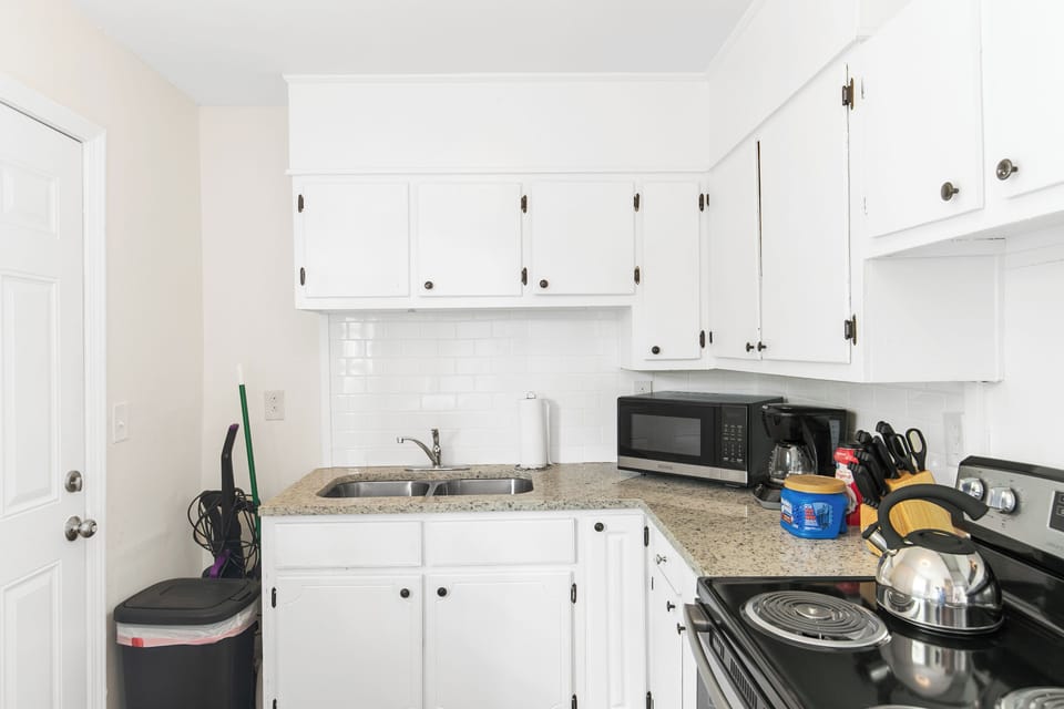 The kitchen is fully equipped for everyday use and includes a grill stored inside for convenience—easily moved just outside the back door when you’re ready to use it.