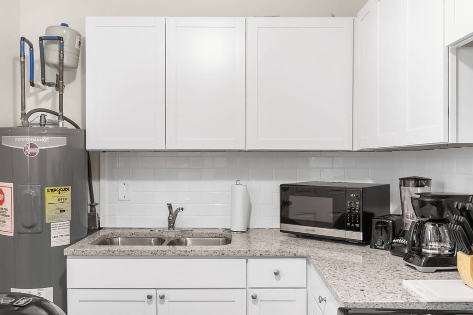 The kitchen is set up for easy use, with a full stove, oven, and coffee maker—open to the living area so everything feels connected.