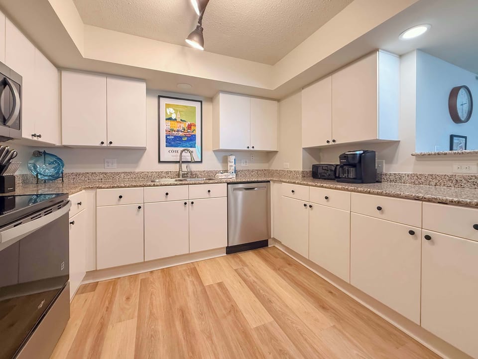 Fully equipped kitchen with stainless steel appliances.