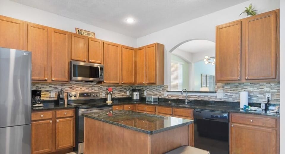 Modern kitchen with granite countertops and stainless steel appliances, ideal for cooking enthusiasts.