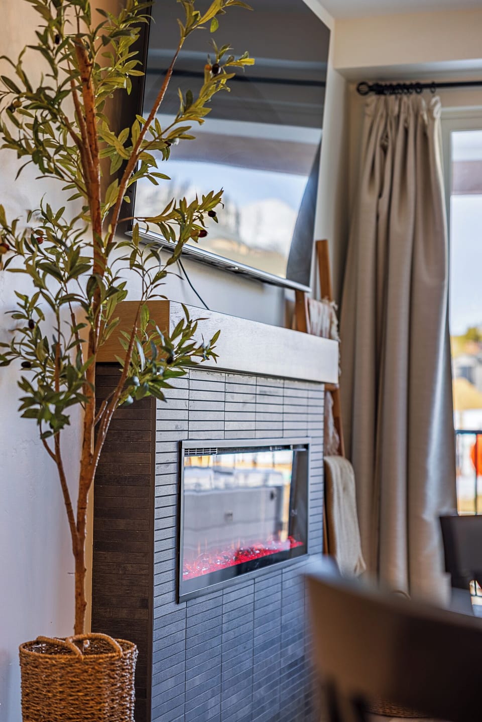 Living Room: Modern elegance with a sleek fireplace and inviting decor for your mountain retreat!