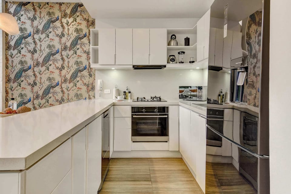 Fully equipped kitchen with sleek cabinetry and modern appliances.