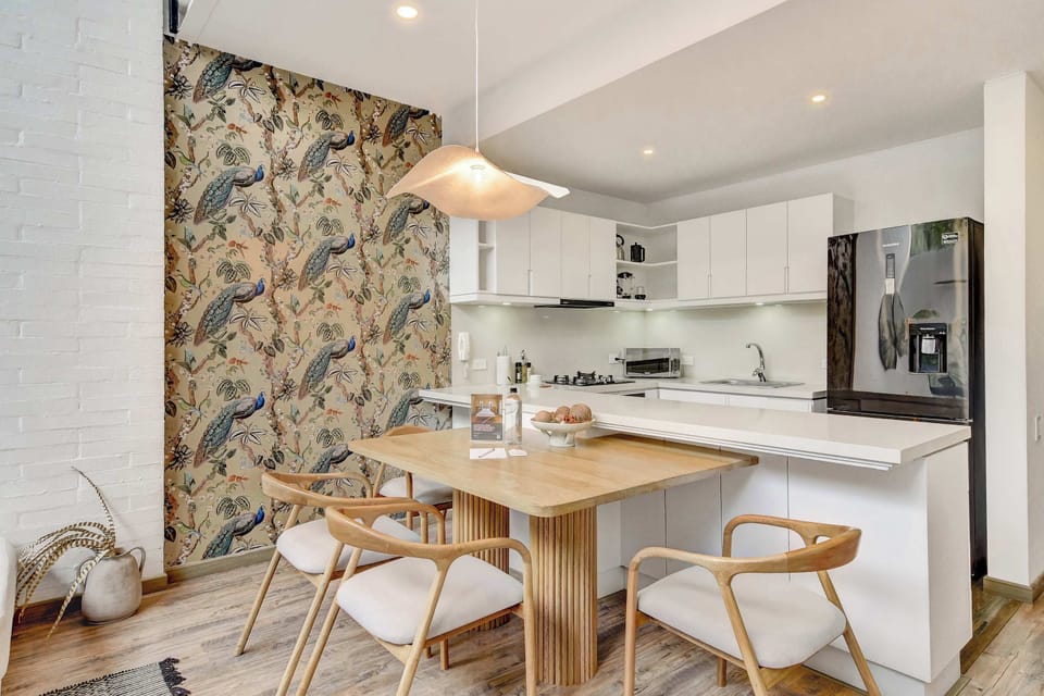 Elegant dining area connected to a fully equipped kitchen.