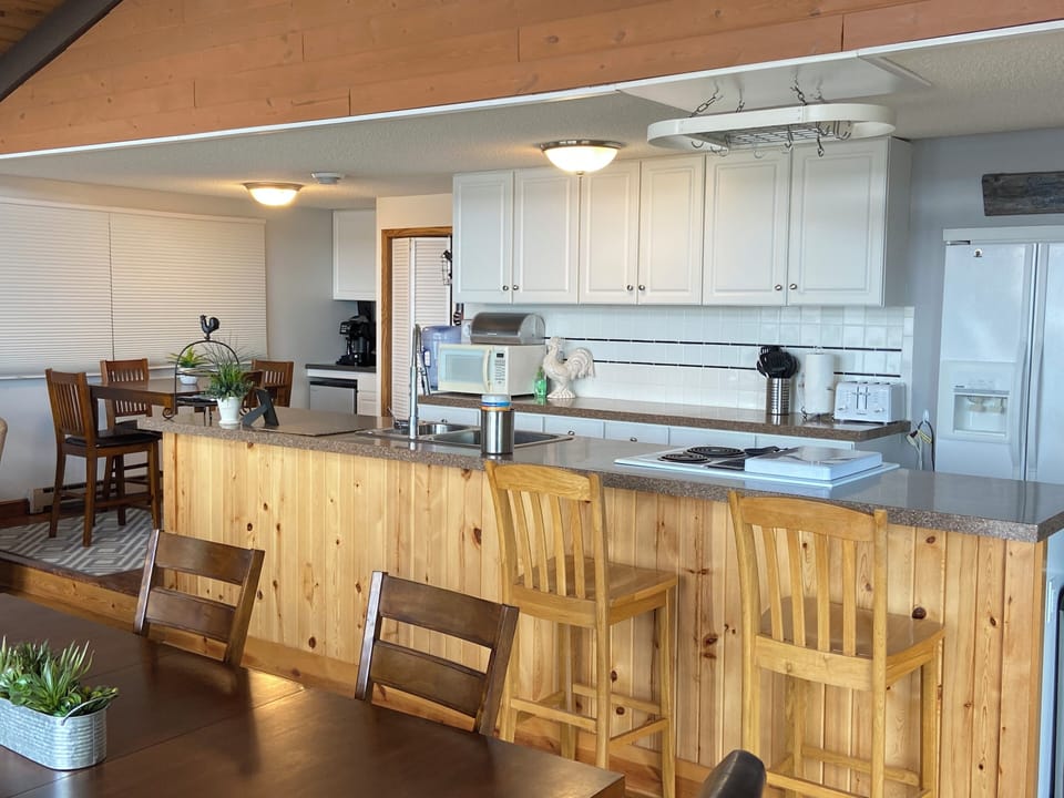 Kitchen; stackable washer/dryer behind bifold door