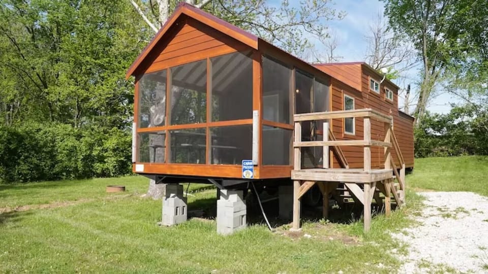 Arrive to a charming cabin with a screened porch retreat.