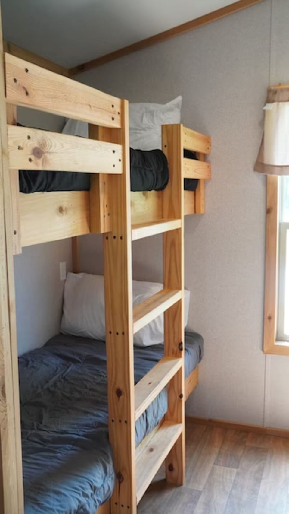 Picture the space with a bright, practical bunk-bed layout.