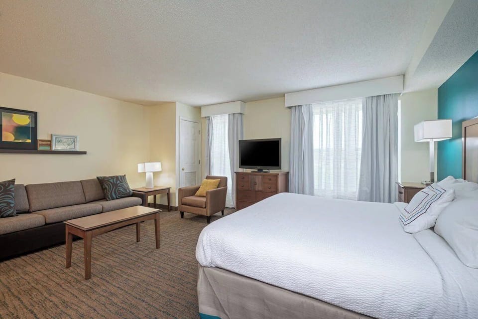 Unwind in a bright suite with plush king bed.