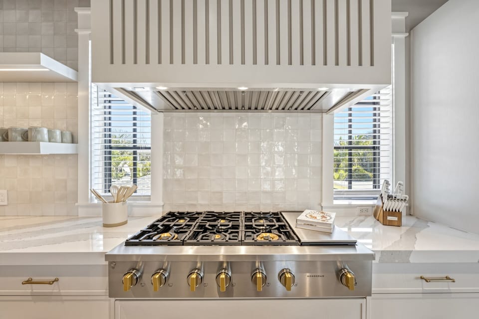 A statement range framed by custom cabinetry and textured tile backsplash.