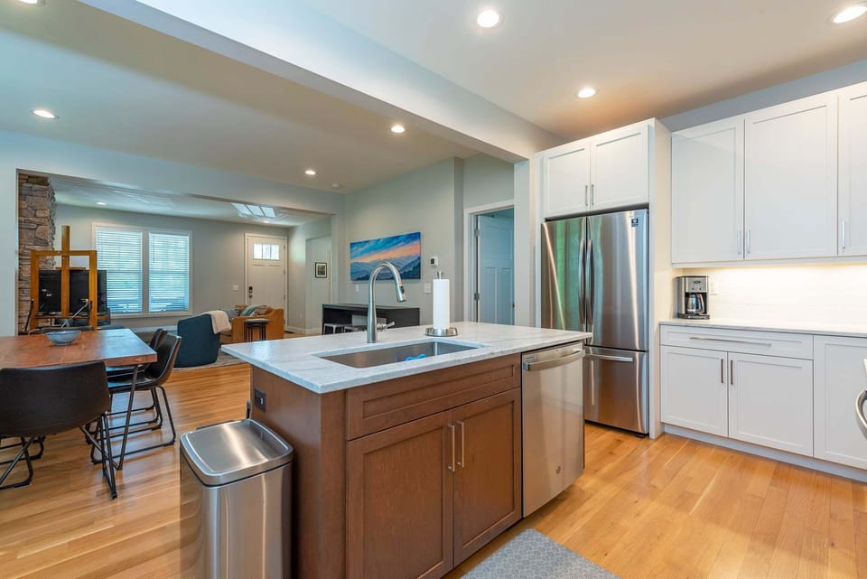 Kitchen with spacious island, gas range, dishwasher, and drip-style coffee maker