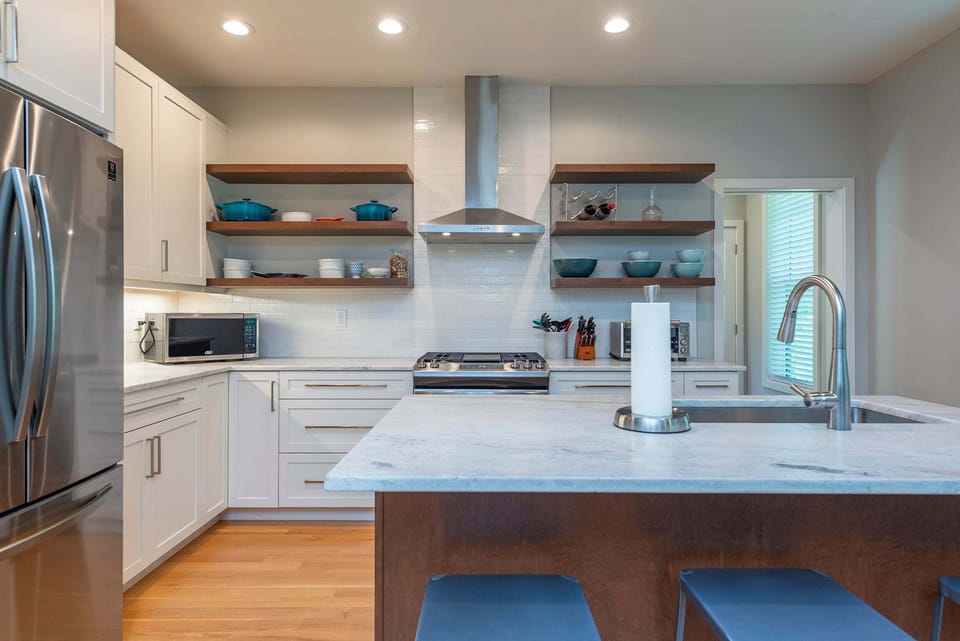 Kitchen with spacious island, gas range, dishwasher, and drip-style coffee maker