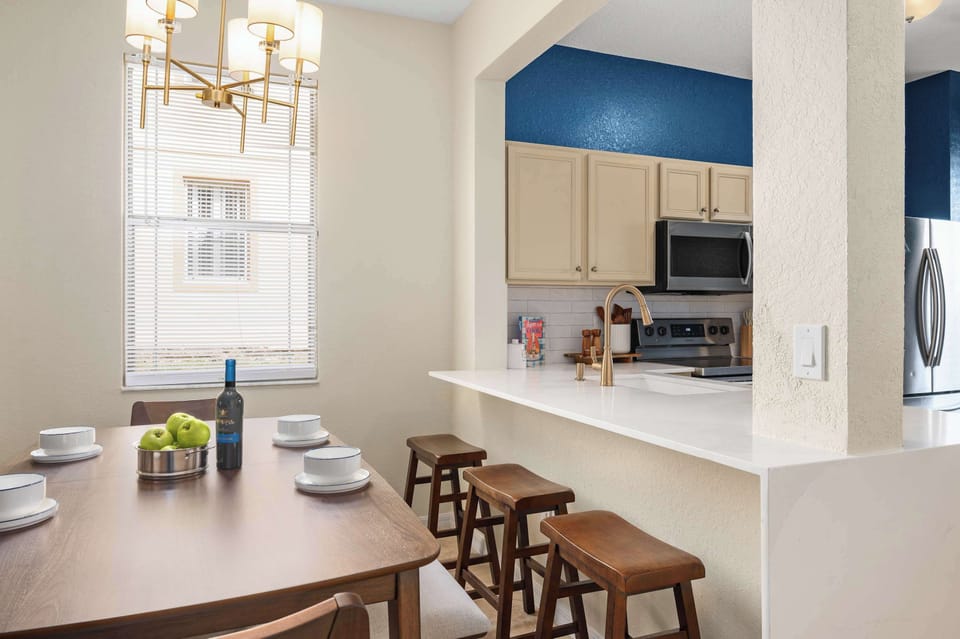 Spacious dining area w/ long table, perfect for shared meals & conversation

