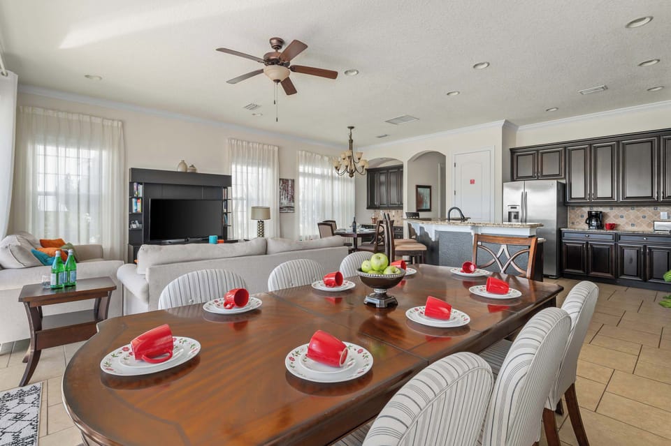 Open kitchen & dining area w/ large table set for a full group meal