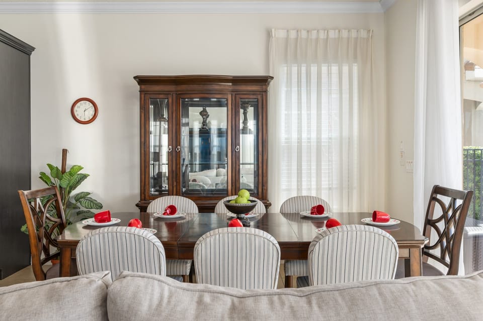 Dining table w/ detailed chairs & bright corner windows for natural light