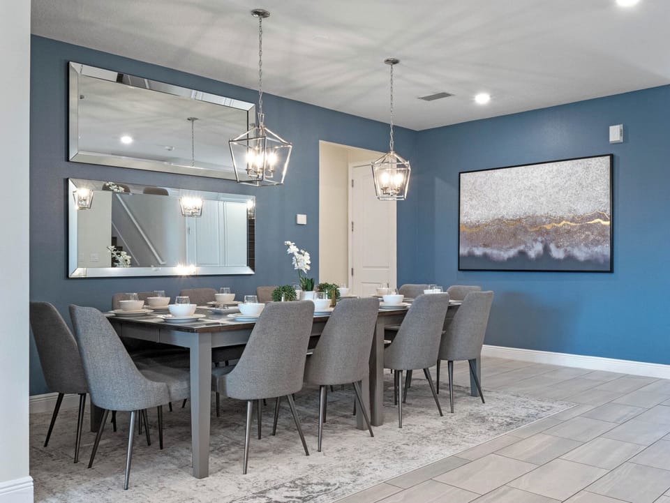 Modern dining area w/ elegant lighting & seating for shared meals and conversation