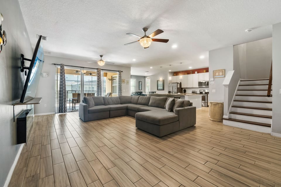 Bright open living room w/ plush seating, high ceilings & space to gather after a fun day out