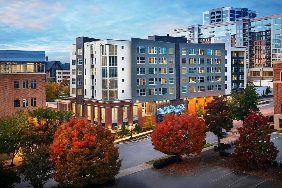 Arrive to a sleek, modern building glowing at sunset.