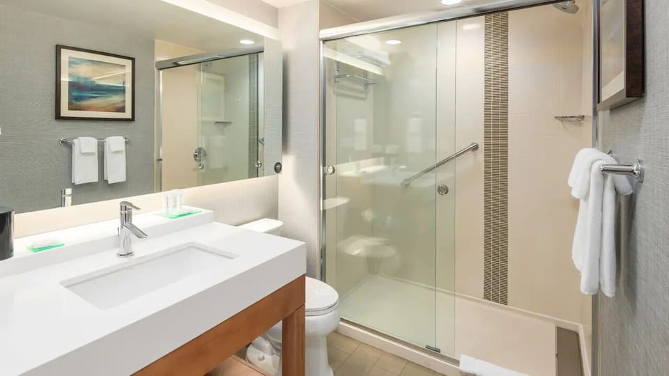 Refresh in a spotless bathroom with sleek glass-enclosed shower.