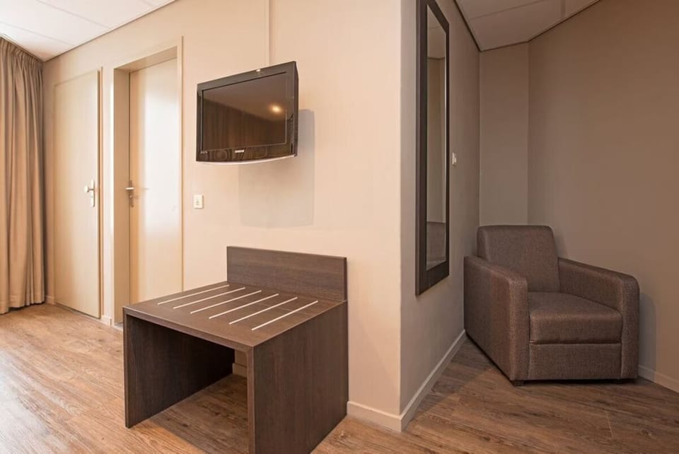 Refresh after sightseeing with a cozy chair and handy luggage bench.